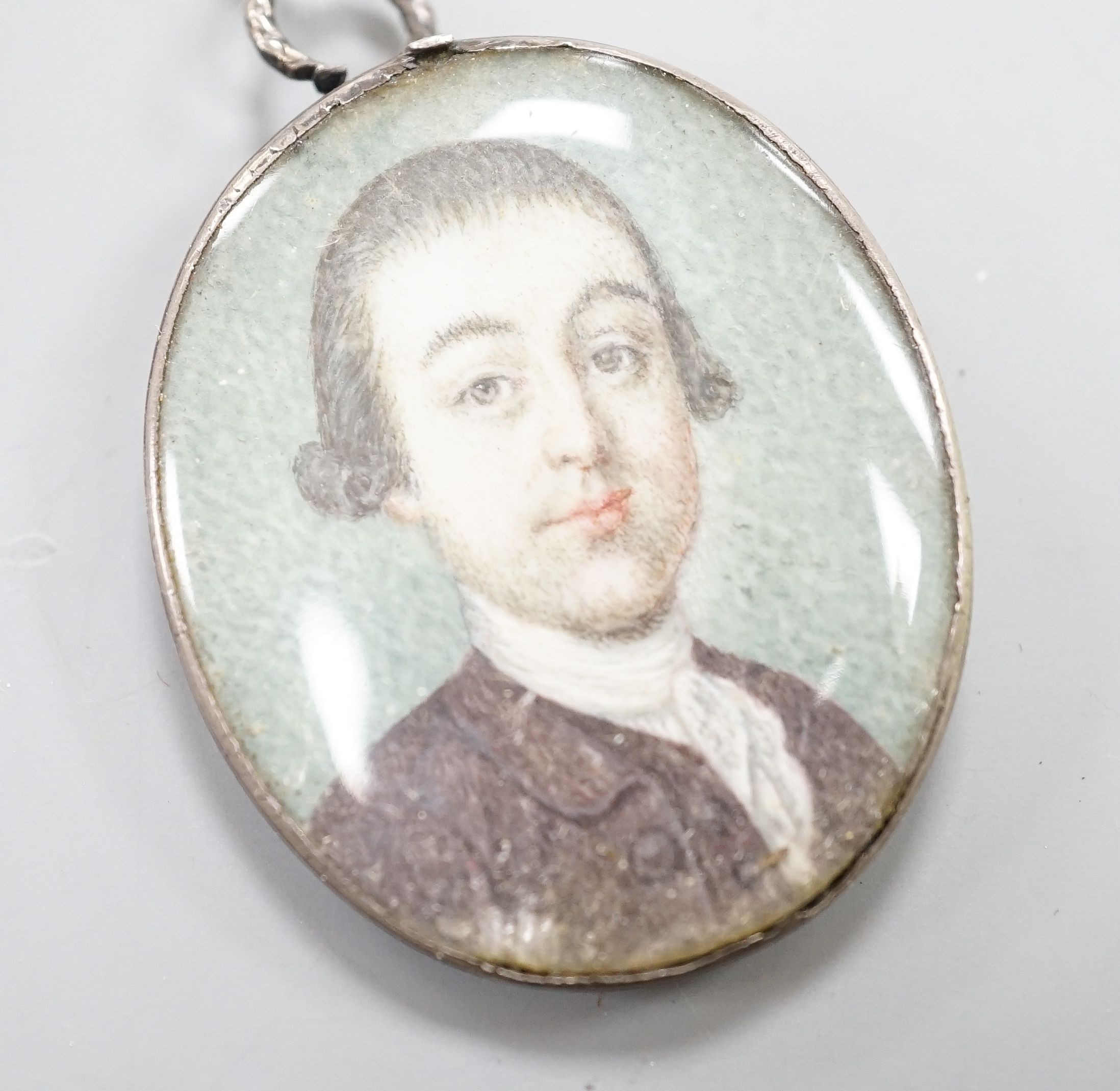 Late 18th century English School, oil on ivory, Miniature portrait of a gentleman in a brown coat 3.5x3cm